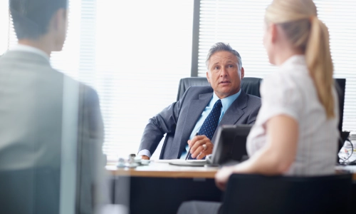 A Tucson boat accident lawyer is meeting with clients to discuss a personal injury case.