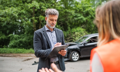 A Tucson hit-and-run lawyer gathering statements from someone who witness the hit-and-run accident of his client.
