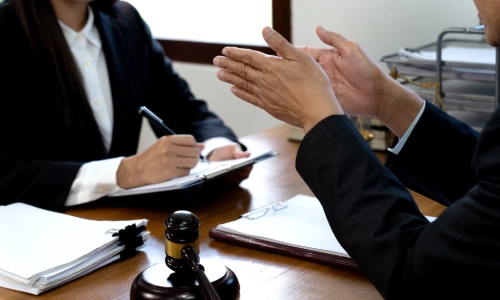 A Tucson premises liability lawyer discussing a client’s premises liability case with the legal team.