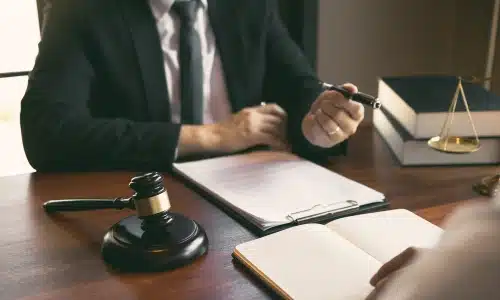 An Acworth brain injury lawyer talking to a client about a legal case in an office.