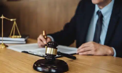 An Acworth daycare accident lawyer sitting at a table beside a gavel.