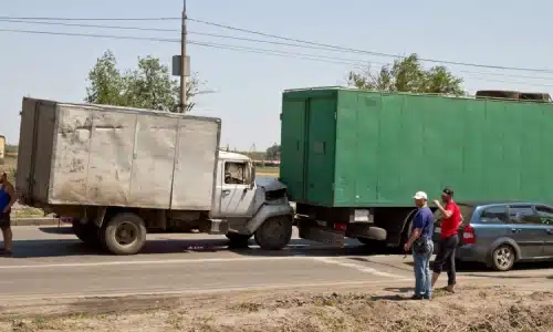 A truck bumps into another truck on the road during a traffic accident.