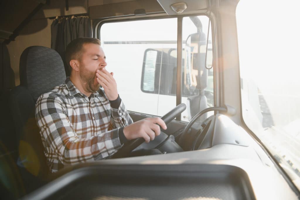 fatigued man driving an 18 wheeler